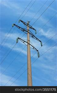 High voltage power pole against the blue sky