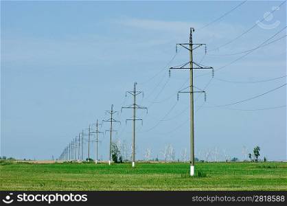 High voltage power pole on green field