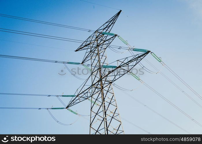 High-voltage tower on a blue sky of background.