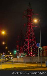 High voltage towers in Riga streets lightened with colourful lights in evening due to New year celebration