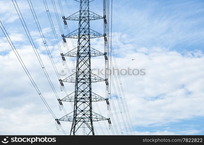 High voltage towers. The meadow below. Industry and nature coexist in appropriate Slightly cloudy sky.And sailed through the air.