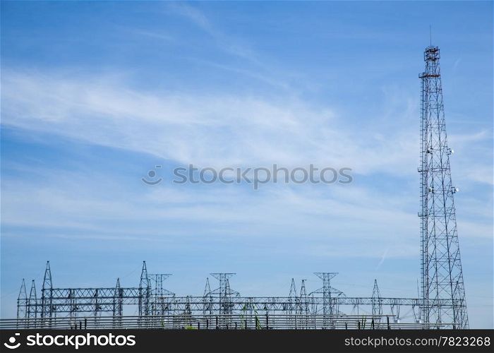 High voltage towers. The meadow below. Industry and nature coexist in appropriate Slightly cloudy sky.And sailed through the air.