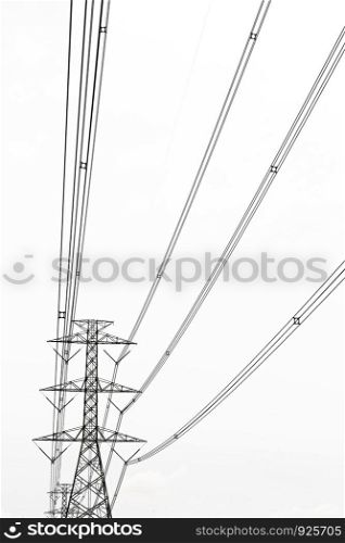 High voltage transmission tower with gray clouds background.
