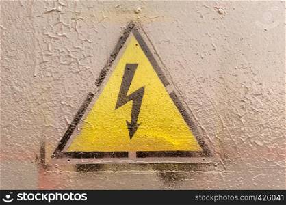 high voltage yellow sign on the painted wall
