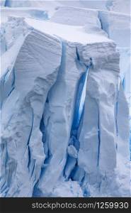 High walls of ice form caves and cracks in glaciers with a shimmering blue passage