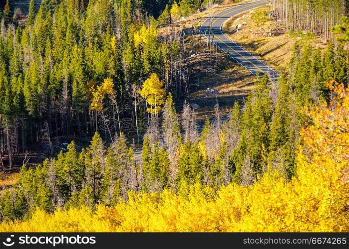 Highway at autumn in Colorado, USA. . Highway at autumn sunny day in Rocky Mountain National Park. Colorado, USA.