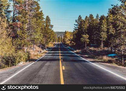 Highway at autumn in Colorado, USA. . Season changing from autumn to winter. Highway in Colorado, USA.