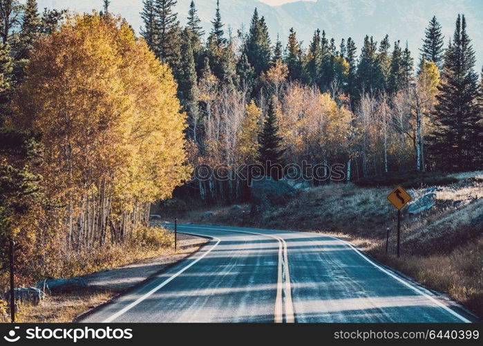 Highway at autumn sunny day in Rocky Mountain National Park. Colorado, USA.