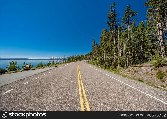 Highway by the lake in Yellowstone . Highway by the lake in Yellowstone National Park, Wyoming, USA