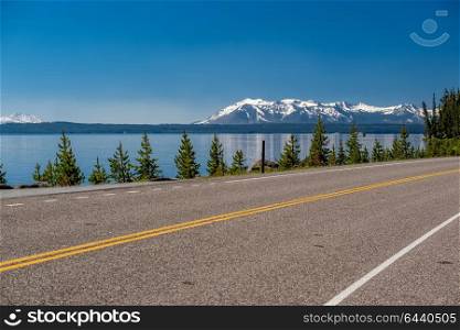 Highway by the lake in Yellowstone National Park, Wyoming, USA