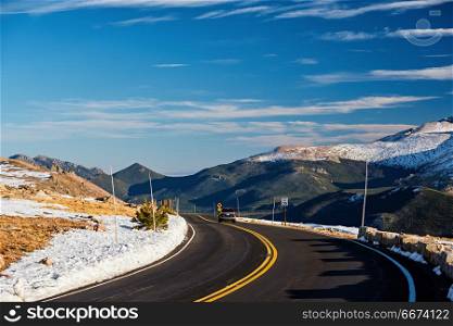 Highway in alpine tundra. Rocky Mountain National Park in Colorado. . Trail Ridge Road, the highest (12,183 feet) continuous highway in the USA in high alpine tundra with rocks and mountains at autumn. Rocky Mountain National Park in Colorado, USA.