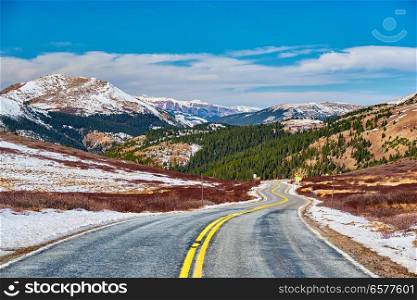 Highway in Colorado Rocky Mountains at autumn, USA