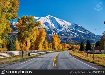 Highway in Colorado Rocky Mountains at autumn, USA. Mount Sopris landscape.