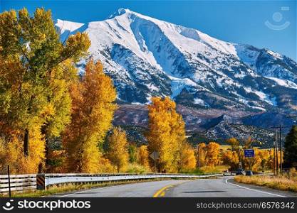 Highway in Colorado Rocky Mountains at autumn, USA. Mount Sopris landscape.