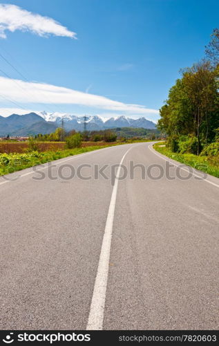 Highway in Piedmont on the Background of Snow-capped Alps, Italy