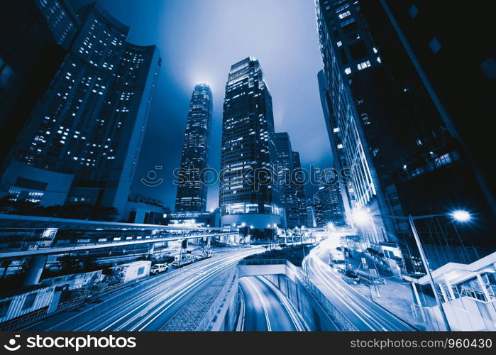 Highway road in Hong Kong Downtown. Financial district and business centers in smart city and technology concept. skyscraper and high-rise office buildings at night. International Finance Center