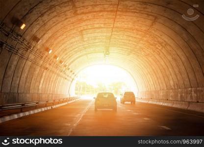 highway road tunnel traffic car speed on street with bright light at end of tunnel