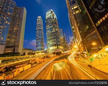 Highway street or road in Hong Kong Downtown. Financial district and business center in urban city. Skyscraper and high-rise office buildings at night. International Finance Center in Central district