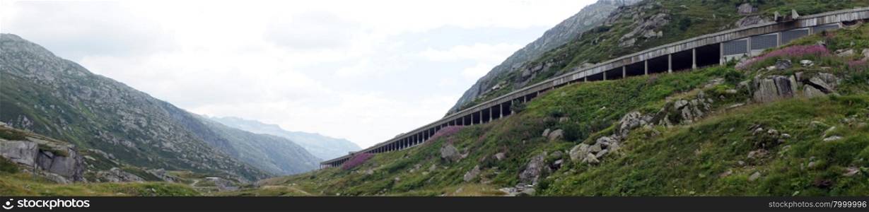 Highway with roof on the slope of mount near Gotthard pass in Switzerland