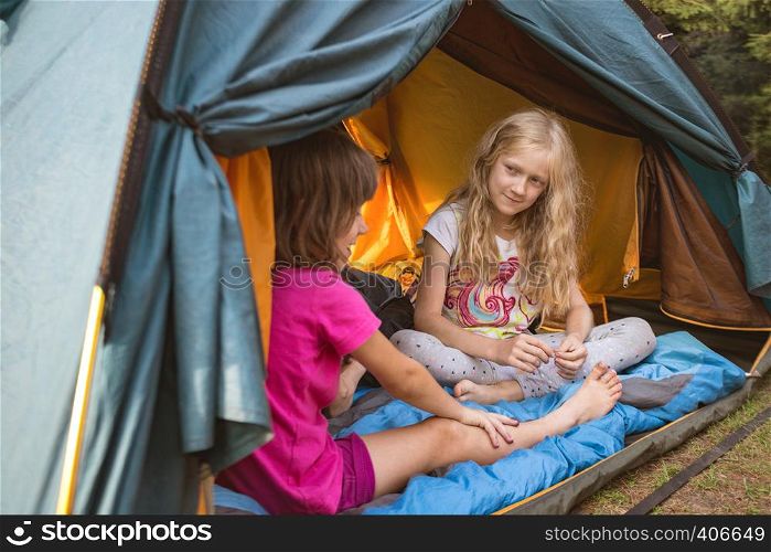 hike and camping life. hiking in the mountains with children - smiling children in a tent