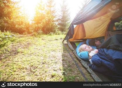 hike and camping life. hiking in the mountains with children - smiling children in a tent