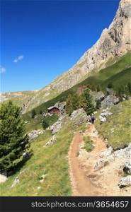 hike beneath Sassolungo mount in Val di Fassa, Trentino, Italy