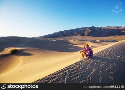 Hike in desert. Hiker in sand desert. Sunrise time.
