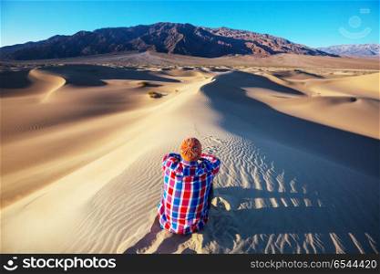Hike in desert. Hiker in sand desert. Sunrise time.