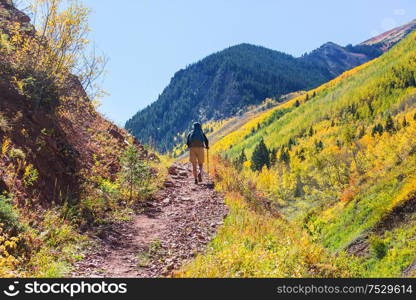 Hike in the autumn mountains. Fall season theme.