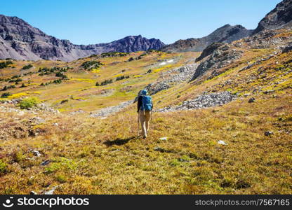 Hike in the autumn mountains. Fall season theme.