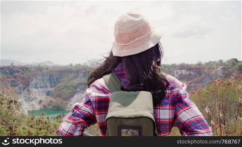 Hiker Asian backpacker woman walking to top of mountain, Female enjoy her holidays on hiking adventure feeling freedom. Lifestyle women travel and relax in free time concept.