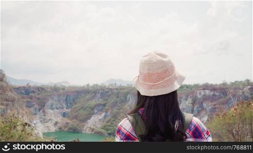 Hiker Asian backpacker woman walking to top of mountain, Female enjoy her holidays on hiking adventure feeling freedom. Lifestyle women travel and relax in free time concept.