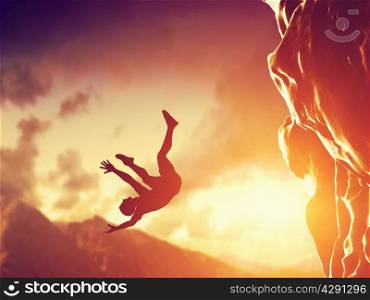 Hiker free falling from the mountain, cliff. Concept of man in dangerous or fatal situation, accident.