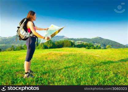 Hiker girl alone looks map