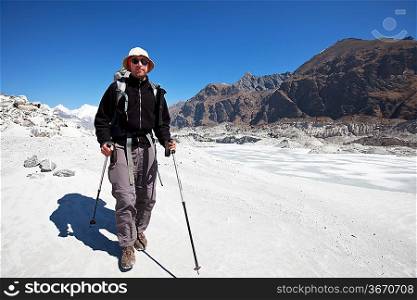 Hiker going along glacier in Himalayan mountain