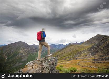 Hiker in beautiful mountains in Tombstone Territorial Park, Yukon, Canada