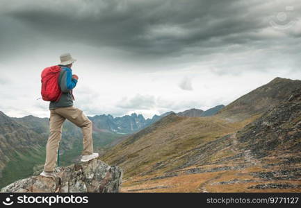 Hiker in beautiful mountains in Tombstone Territorial Park, Yukon, Canada