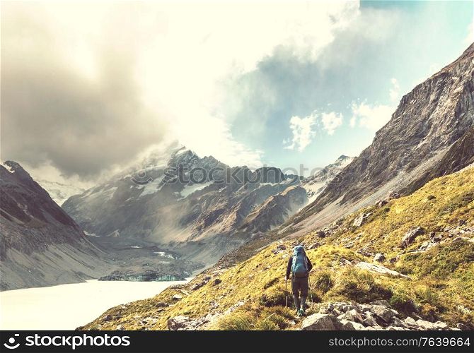 Hiker in beautiful mountains near Mount Cook, New Zealand, South island