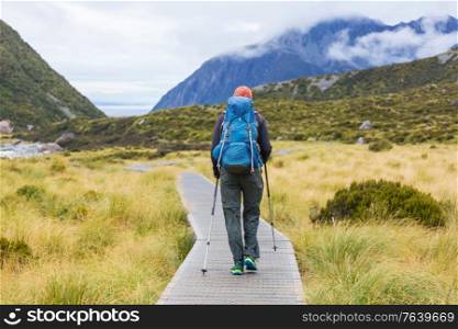 Hiker in beautiful mountains near Mount Cook, New Zealand, South island