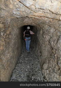 hiker in First world war tunnel in italian Alps