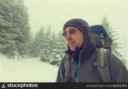 Hiker in winter forest