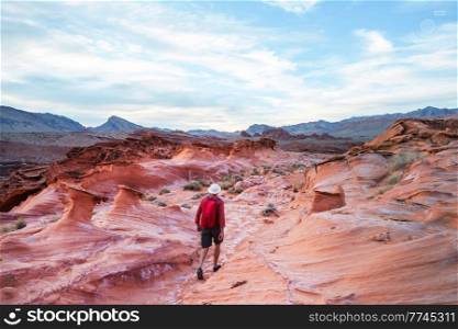 Hiker inside a stone arch in the Nevada desert near Las Vegas, Nevada, USA