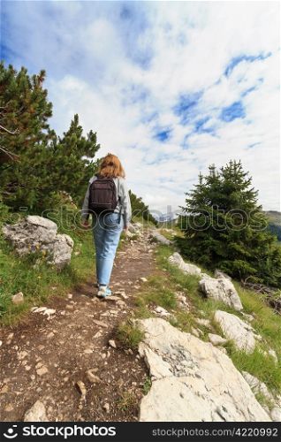 hiker is walking on alpine footpath, Italian Dolomites