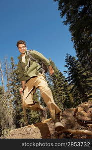 Hiker Jumping Off Log