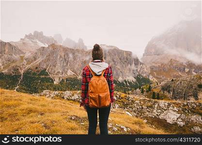 Hiker looking out at Mount Lagazuoi, Dolomite Alps, South Tyrol, Italy