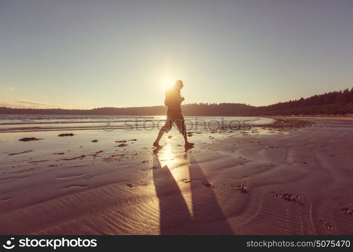 Hiker man in hike along sea coast