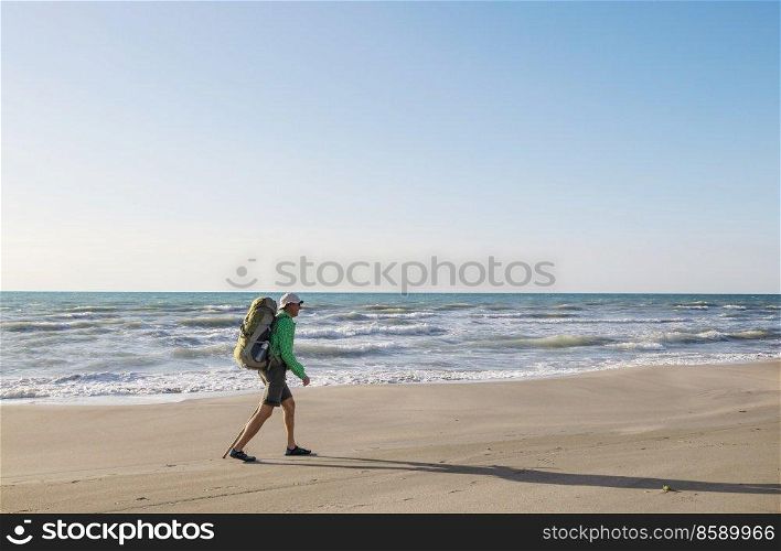 Hiker man  in hike along sea coast