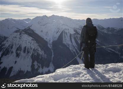 Hiker on snowcapped mountain in valley, Kicking Horse Mountain Resort, Golden, British Columbia, Canada