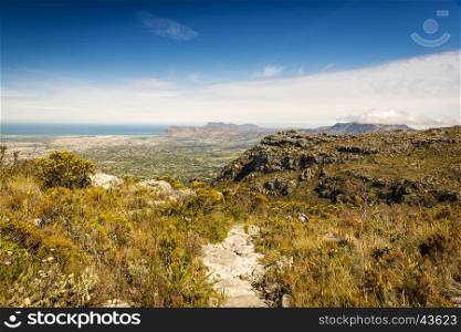 Hiker on Table Mountain track with Cape Town in the background