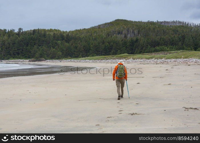 Hiker on the beach on Vancouver island, British Columbia, Canada